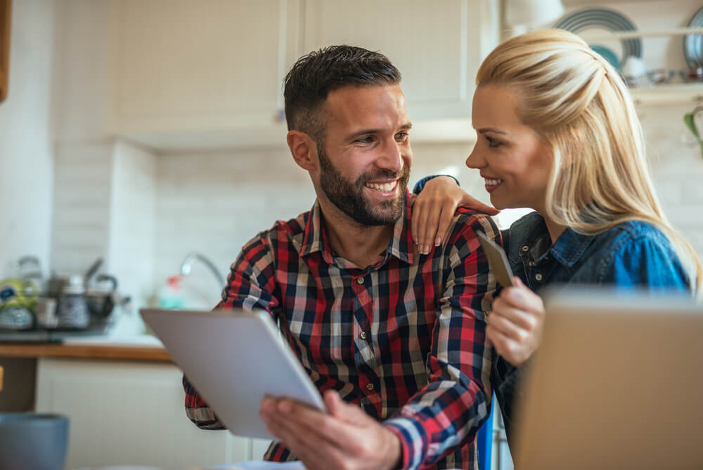 Couple smiling over laptop